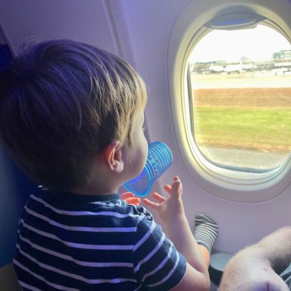 toddler looking out airplane window